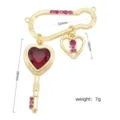 Detailed view of 18k gold-plated brass DIY jewelry accessory with red zircon heart key. - Safety Pin Key Heart Pendant (#1) / Gold
