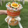 Handmade crochet sunflower bouquet gift with orange floral wrapper and ribbon for romantic occasions. - Xiao Xiang Style 11-Flower Smiley Wool Sunflower