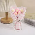 Handmade knitted puff flower bouquet in pink checkered wrapping paper for romantic gifts. - Pink