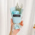 Detailed shot of mini blue soap rose bouquet with dried grass, elegant gift packaging design. - Light Blue