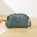 Stylish minimalist teal leather crossbody shoulder bag with multi-zipper compartments. - Blue