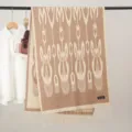 Detailed view of brown ethnic pattern woven winter scarf with fringe design and soft fabric texture. - Xinjiang Shawl Style 7