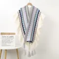 Detailed view of the ethnic knitted poncho with colorful wavy stripes, ruffles, and tassels. - Ruffle Pendant Shawl G