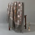 Close-up detail showing the exquisite floral embroidery and fringe on the shawl. - Gray