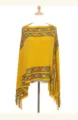 Detailed close-up view of the vintage ethnic style yellow knitted poncho with elegant tassels. - Yellow