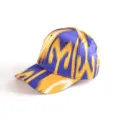 Close-up detail of Xinjiang ethnic style silk baseball cap showing blue and yellow pattern. - Atlas Pattern 11