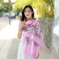 Pink embroidered cashmere scarf with colorful floral patterns and elegant fringe design. - Glitter