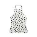 Top licou chic à pois noirs et blancs avec bas de jupe évasé pour un look estival élégant. - Pois
