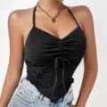 Detailed view of women's black halter neck eyelet embroidery crop top with ruched drawstring design. - S / Tops / Black