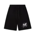 Detail view of the skull and butterfly graphic print on the black casual shorts fabric. - S / Bottoms / 302 Black