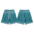 Detail view of gradient wash cargo shorts, featuring multi-pockets, drawstrings, and letters. - S / Bottoms / Washed Lake Blue