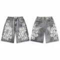 High-street washed denim shorts with gothic number patch embroidery and splatter paint. - 38 / Bottoms / White