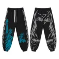 Black high street casual pants with Statue of Liberty print, side lightning stripes, and graphic text. - S / Bottoms / Black and Gray