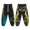 Black streetwear sweatpants with yellow lightning and Statue of Liberty prints for men women - S / Bottoms / Black and Yellow