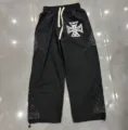 Detailed view of black casual trousers with rhinestone details and cross graphic print for daily wear. - S / Bottoms / Black