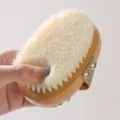 Wooden oval bath body brush with soft nylon bristles and hand strap for shower cleaning. - 11.5x8cm / Natural Wood Color