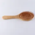 Natural bamboo air cushion paddle hair brush for daily scalp massage and smooth styling. - Round Head Style