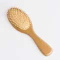 Wooden hair brush with massage pins and air cushion, ergonomic beech wood handle design. - Medium Size