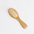 Wooden hair brush with air cushion and massage pins for anti-static daily hair care use. - Small Size