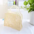 Large transparent PVC cosmetic bag with stylish beige vertical stripes and handy carry handles. - Beige