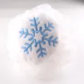 White mesh bath sponge detail close-up showing cute blue embroidered snowflake plush patch. - White Snowflake