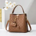 Brown checkered bucket bag with top handle, crossbody strap and chic mini charm. Stylish daily use. - Dark Brown