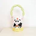 Cute cartoon panda cake print bucket bag with padded green handle, stylish and sweet tote. - Cotton-Padded Bucket Bag / Cake Panda