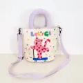 Cute polka dot cat canvas bucket bag with purple handle and crossbody strap, stylish design. - Skateboard Pink Cat Crossbody Style