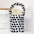 Small white canvas bucket bag with black polka dots and twisted handle, casual daily handbag. - Polka Dot Bucket Handbag