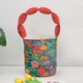 Canvas bucket bag with colorful floral print and red padded handle, chic daily. - Red Floral