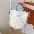 Floral quilted tote bag with blue handles and purple shoulder strap, casual canvas handbag. - Gourd Quilted Bag / Yellow Floral