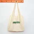 Beige canvas tote bag with green letter print, casual large capacity daily shoulder bag. - AREYOU Vest Bag / Beige
