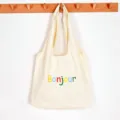 Beige canvas tote bag, large capacity Korean style lazy shoulder bag with colorful Bonjour text. - Beige