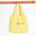 Yellow canvas tote bag with colorful Bonjour print, large capacity casual shoulder bag. - Yellow
