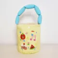 Cute yellow canvas bucket bag with blue padded handle and fun cartoon fruit print for women. - Apple Print / Blue Handle