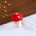 Closeup of handmade red and white wool felt mushroom craft, perfect for DIY hair accessories. - Red Mushroom