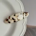 Detail view of French retro acetate oval hair clip, elegant design tortoiseshell clip for women. - Brown and White