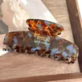 Detailed close-up of the elegant acetate hair claw featuring a vintage tortoise shell pattern. - Green
