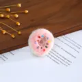 Handmade felt donut charm with colorful beads for DIY crafts and hair accessories detail. - Pink Donut