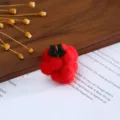 Closeup view of red wool felt fruit accessory with green leaves for DIY crafts and hair clips. - Red Grapes
