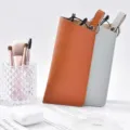 Detailed view of portable leather glasses pouch with lychee pattern, snap button and hanging strap. - Spring Ring Glasses Pouch Grey