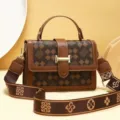 Sac bandoulière marron à motif monogramme et large sangle, vue détaillée rétro et tendance. - Trèfle à quatre feuilles