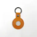 Orange leather protective case compatible with tracker, featuring a metal keyring and snap. - Orange