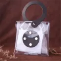 Detailed view of the clear PVC mask storage pouch with black leather handle and snap button. - Black