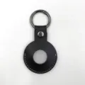 Black leather protective case detail view, circular tracker holder with metal keychain ring. - Black