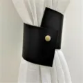 Minimalist black PU leather curtain tieback with gold button detail, elegant home decor accessory. - Black