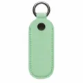 Vista detallada de la funda protectora de cuero para memoria USB con llavero y botón metálico. - Verde