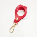 Red leather golf ball holder keychain with gold hardware, single ball storage bag for sports. - Red