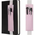 Detailed view of pink leather elastic band pen holder attached to notebook and solo close-up. - Pink
