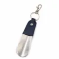 Detail view of the portable metal shoehorn keychain with premium leather wrapped handle. - Blue